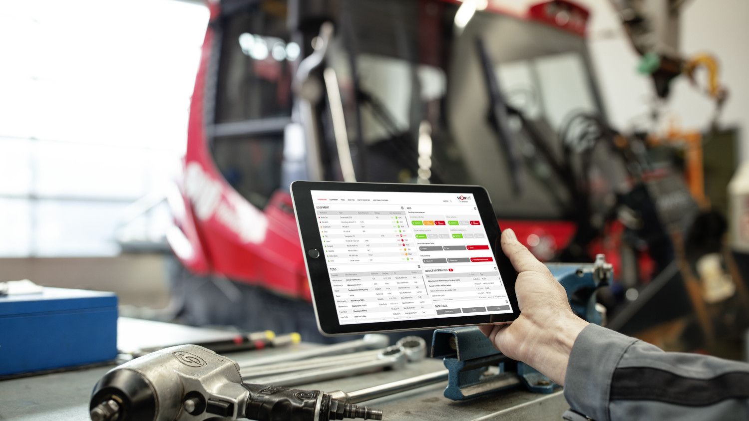 SNOWsat sur la tablette, avec un PistenBully en arrière-plan